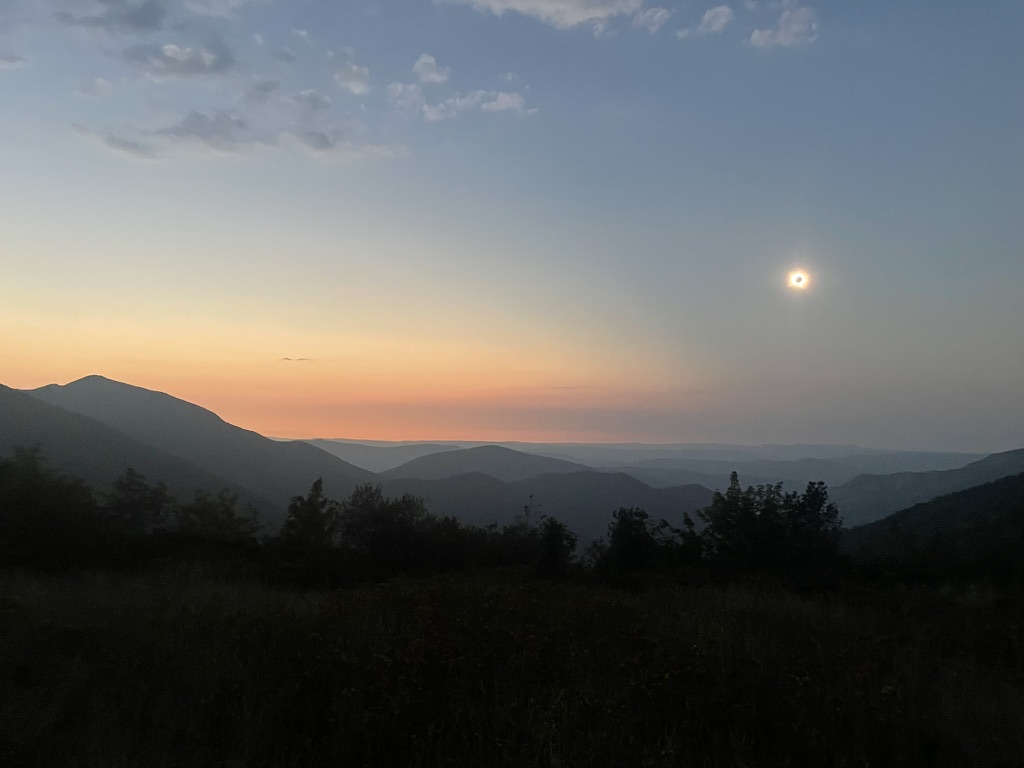 The total solar eclipse over the mountains of Asturias, Spain, on August 12, 2026, with the black disk of the Moon surrounded by the Sun’s corona.